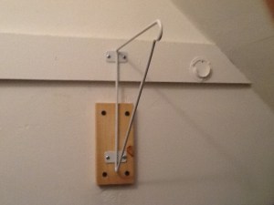 The support with a one by four mounted to the wall to provide an anchor.